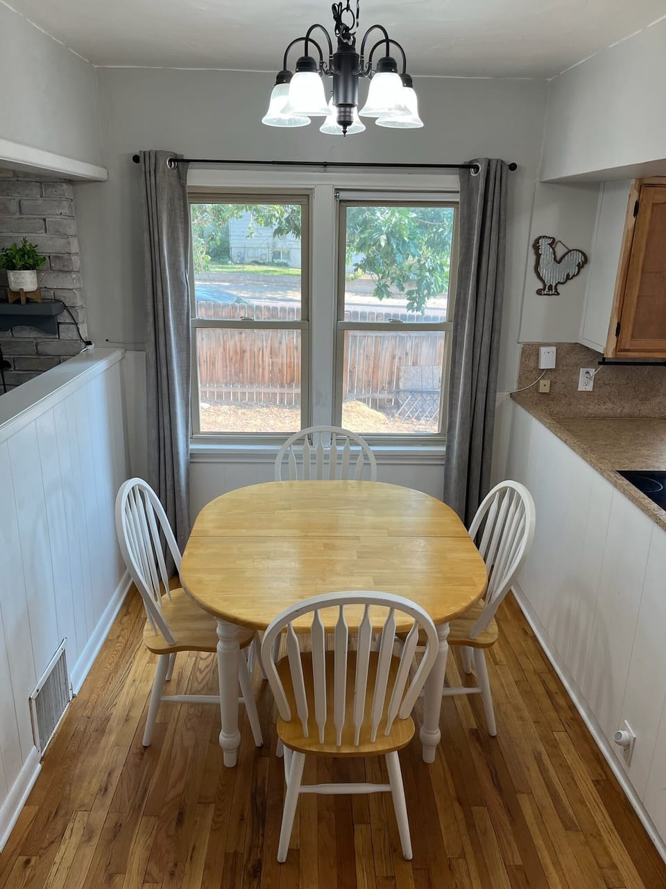 Bright dining space with large windows overlooking the side yard.