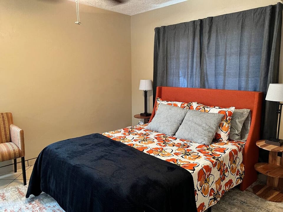Bedroom - Queen Bed, Seating, Lamps, and Bathroom Connected