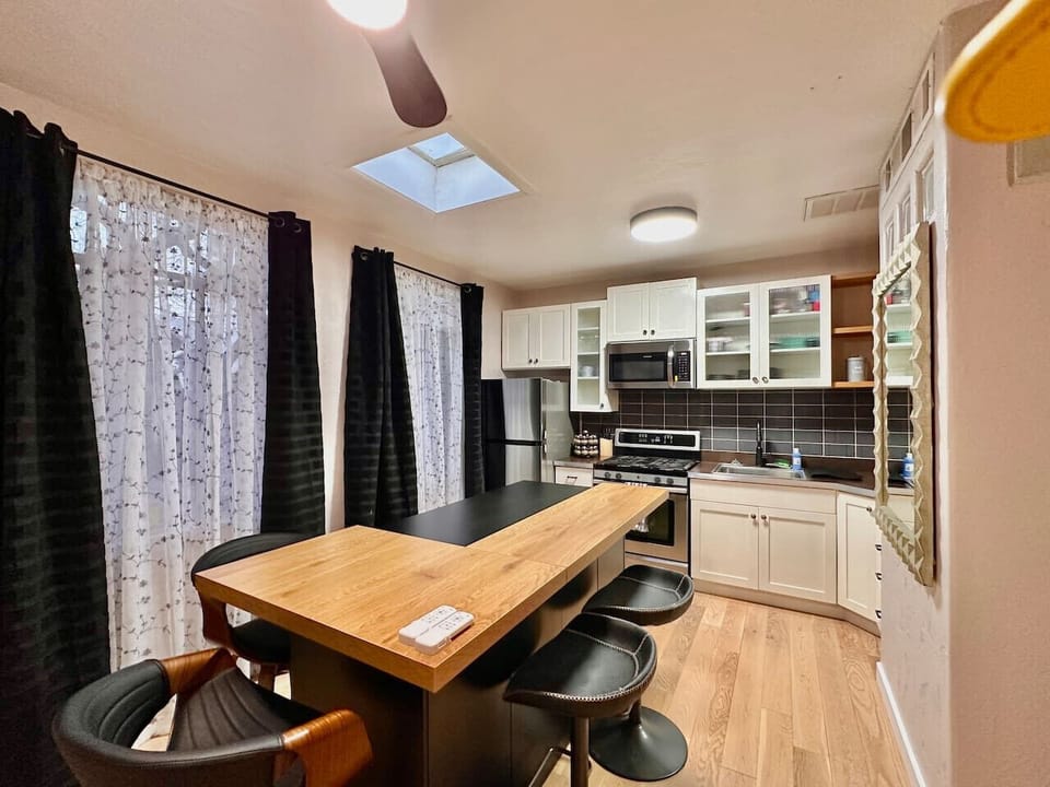 Kitchen - Modern Appliances, Island Seating, and Cabinet Space