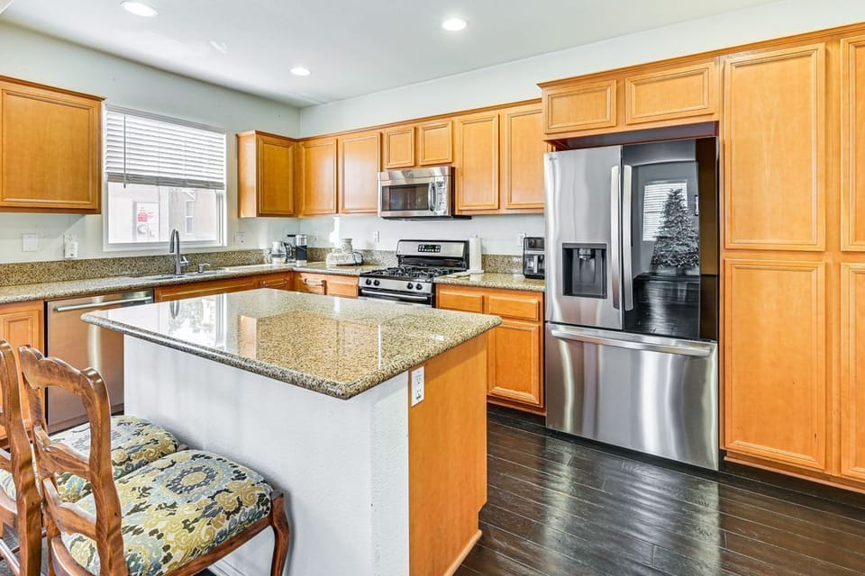 Island kitchen with upgraded appliances. 