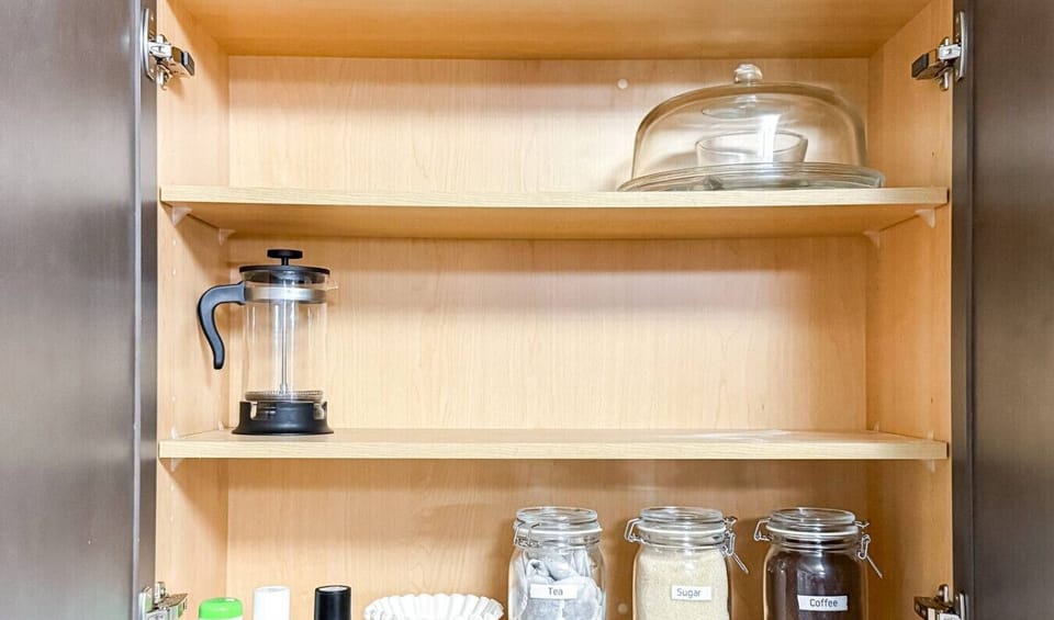 Kitchen pantry stocked with coffee, tea, sugar, and other essentials for your morning routine.