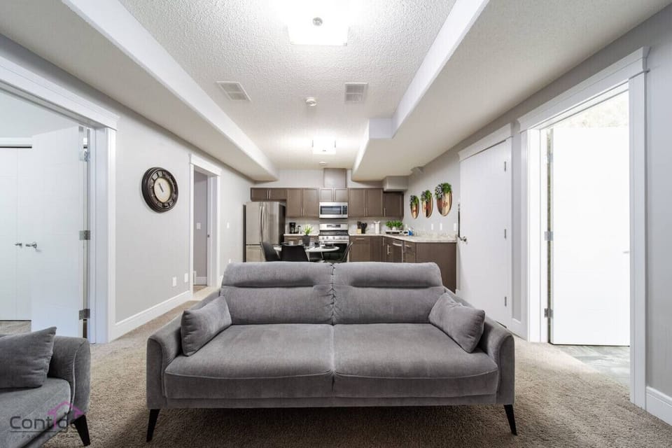pacious open-concept design connecting the living room and kitchen, creating a warm and inviting space for groups and families.