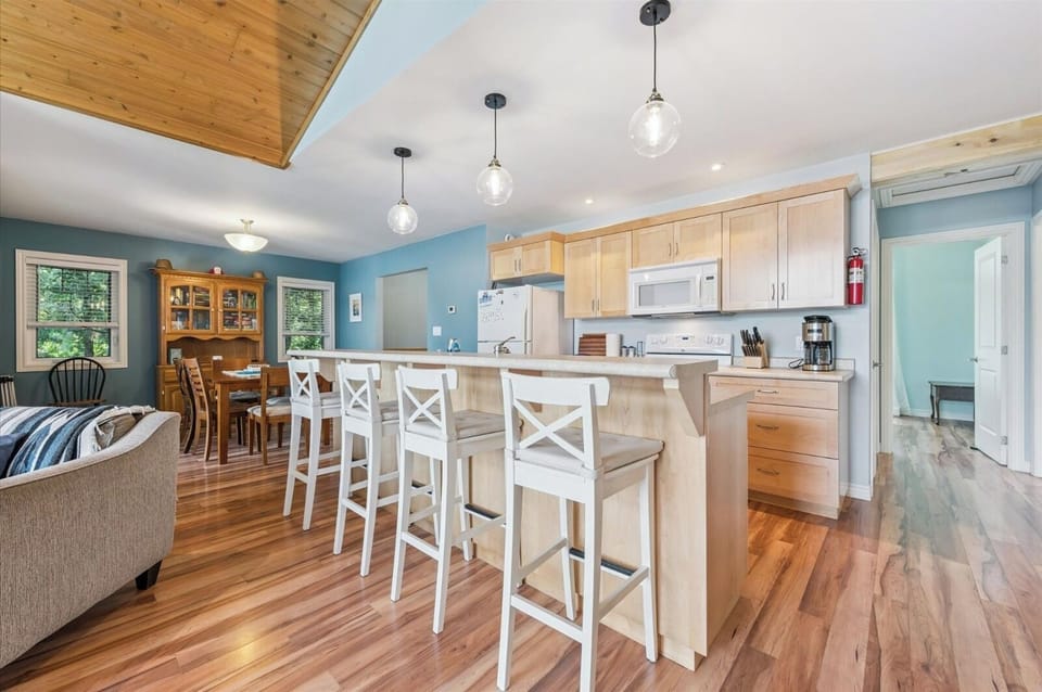 Spacious kitchen with breakfast bar seating for four, perfect for casual meals and conversation.