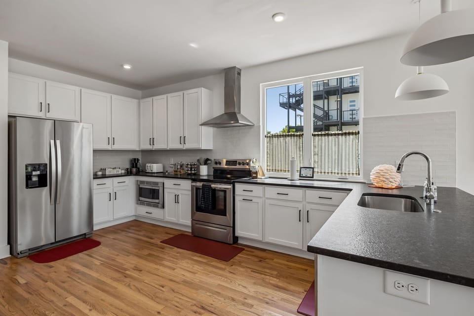 Kitchen: Spacious kitchen featuring essential cookware, appliances, and a comfortable setup for home-style meals.
