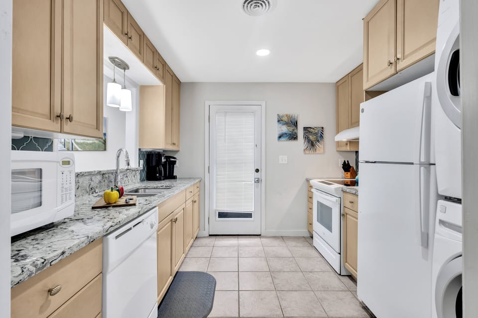 Kitchen with microwave, coffee maker, stove, dishwasher, and refrigerator
