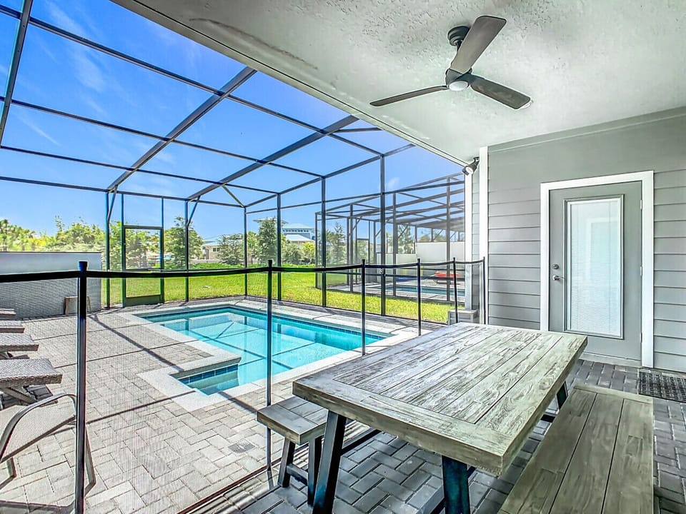 Covered outdoor dining area with pool views.