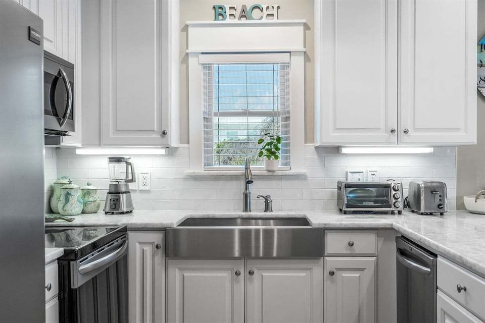 Coastal-inspired kitchen with modern amenities and small appliances for your convenience.