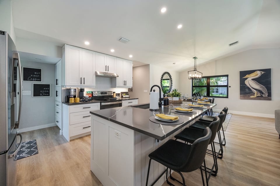 Large island with breakfast bar; dining table beside for easy family meals.