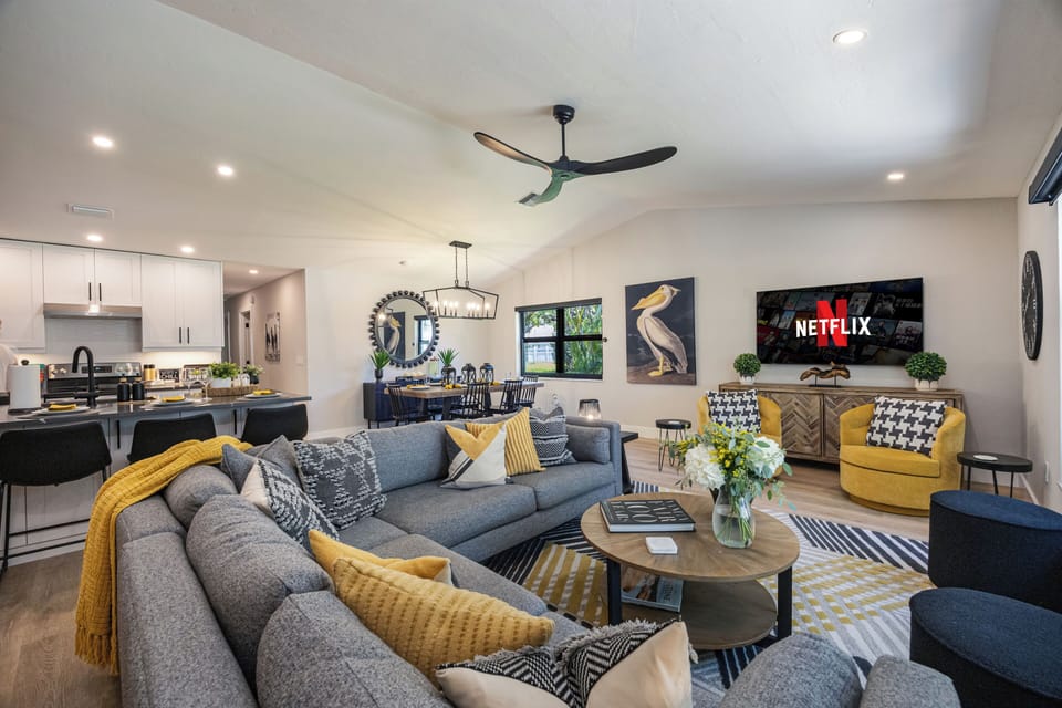 Bright living room; seamless flow to kitchen - bar for 4, table for 6.