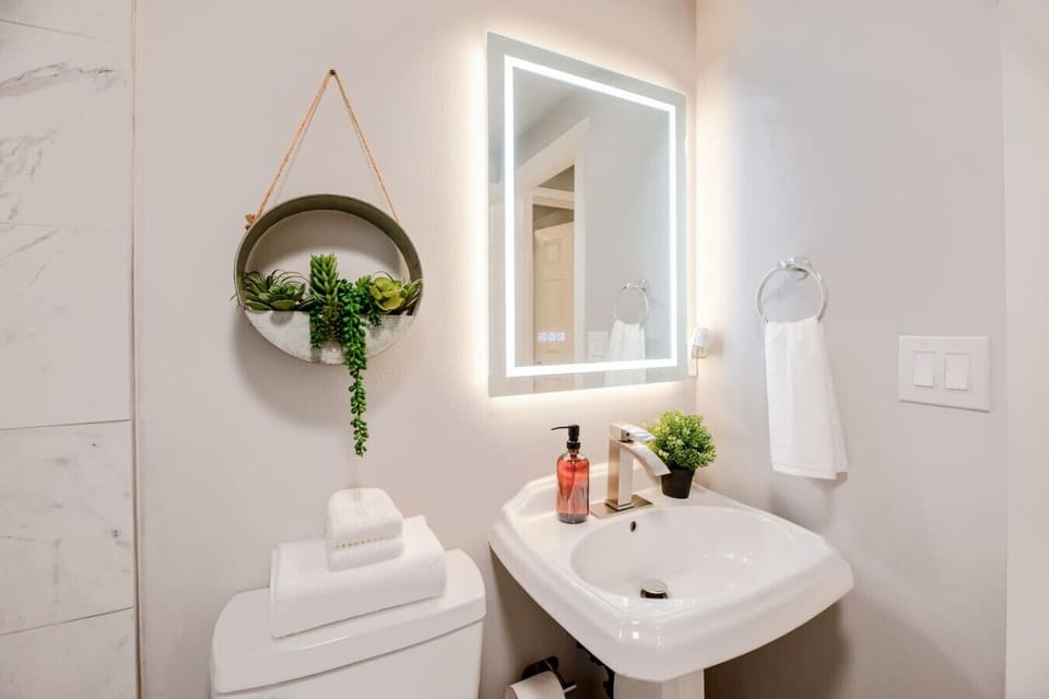 Unwind in this sleek bathroom featuring clean lines, modern fixtures, and a refreshing atmosphere. Perfect for pampering yourself after a day exploring the city.