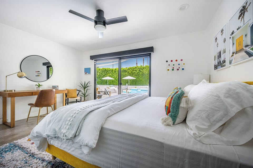 Colorful king room: desk, blackout shade, sound machine, bedside chargers, views