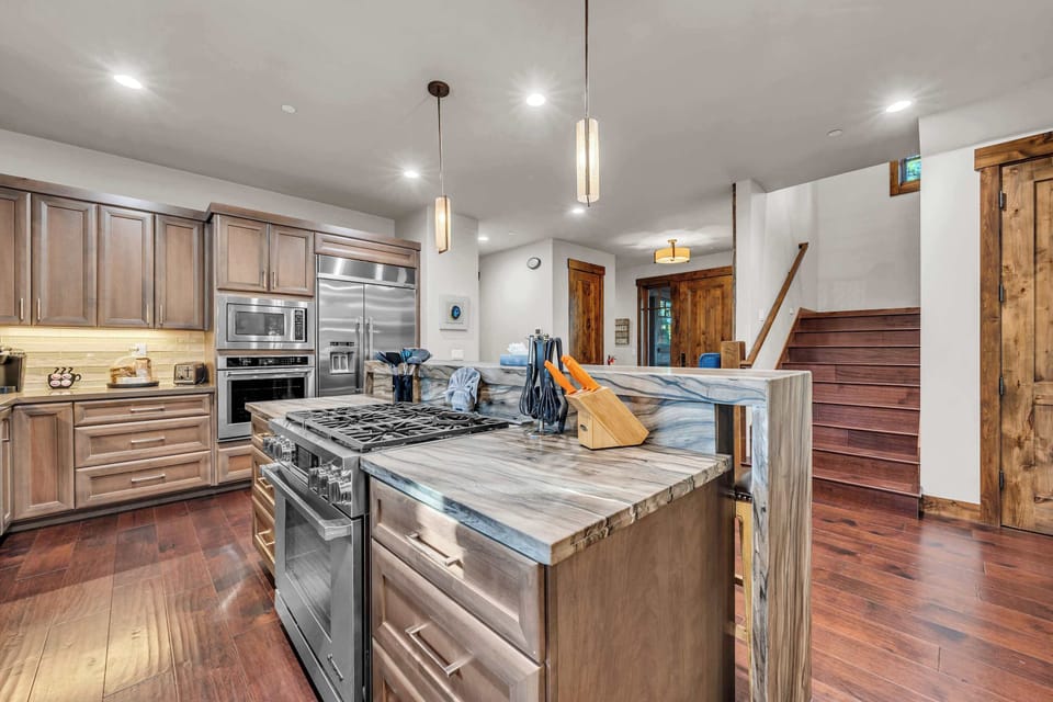 Kitchen: Main floor, drip coffee maker, Keurig, toaster, food processor, cooking utensils, tableware
