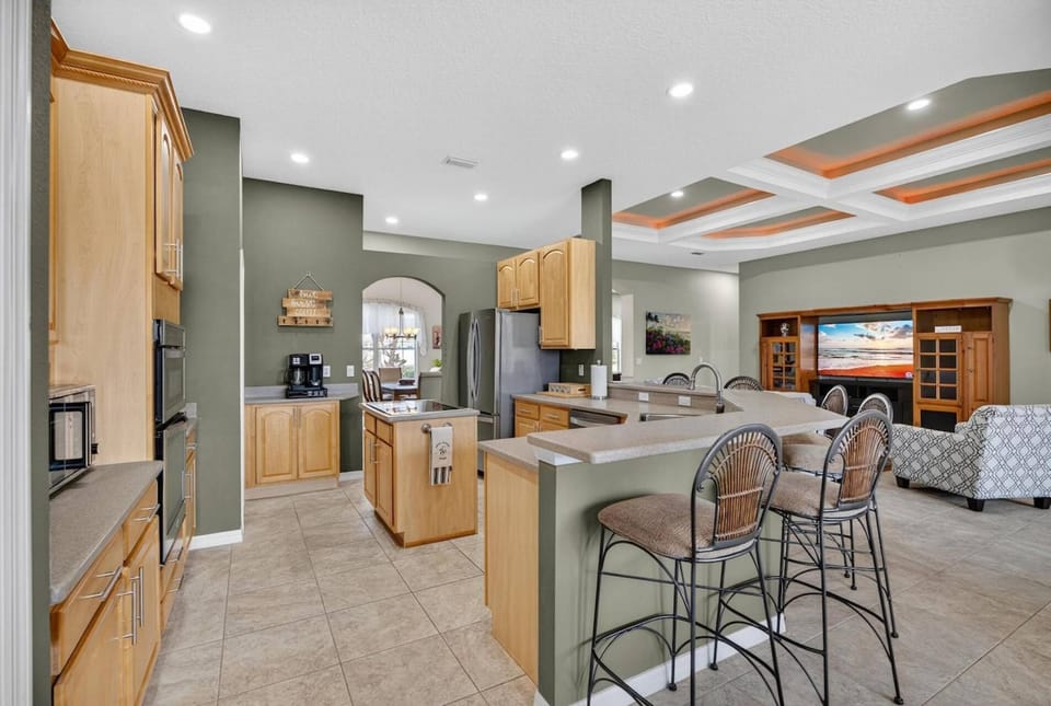 Spacious kitchen area overlooking the living space, lanai, and charming eat-in nook for casual dining.