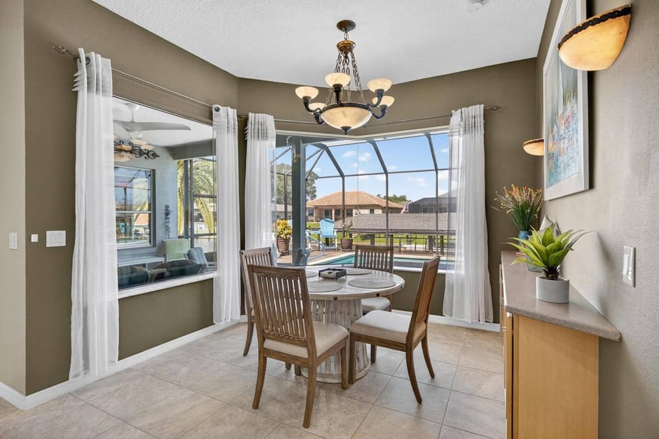 Cozy breakfast nook with stunning views of the pool and serene canal for a peaceful start to your day.