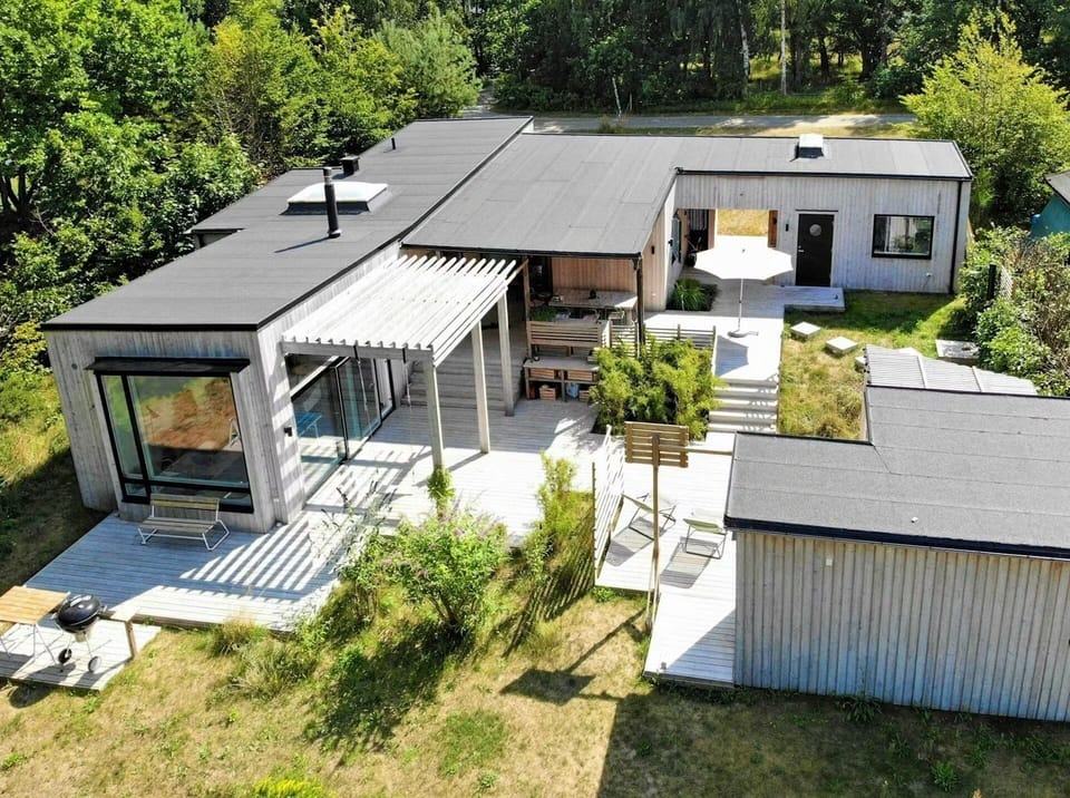 Architect-designed home with spacious patio surrounded by nature.