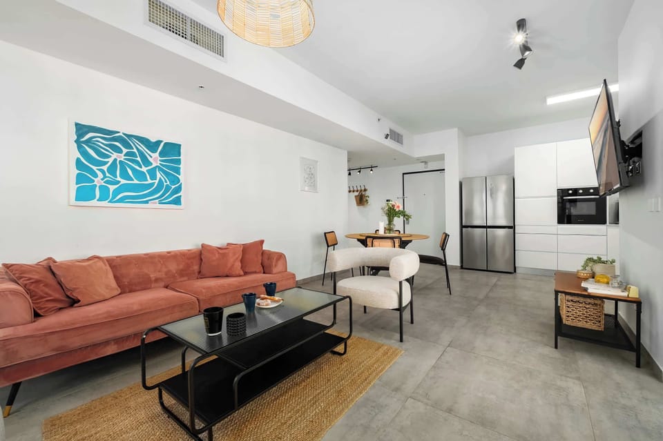 Spacious living room anchored by soft sofa and modern décor, perfect for relaxing evenings indoors.