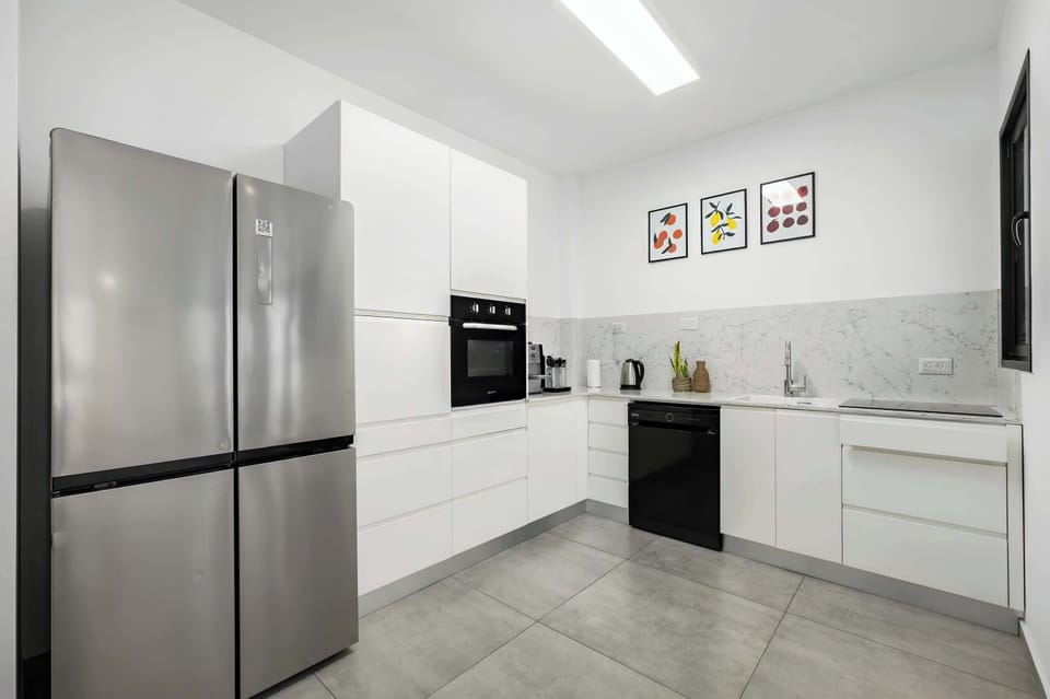 Modern kitchen with sleek cabinetry, full appliances, and generous space for preparing relaxed home-style meals together.