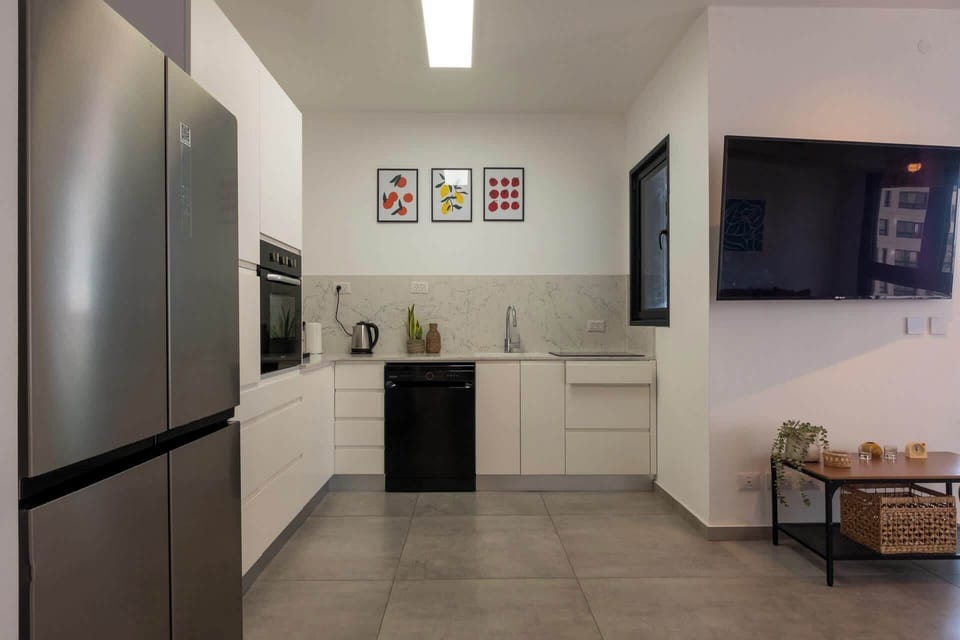 Bright kitchen corner beside living area, thoughtfully equipped for effortless breakfasts, coffee moments, or simple meals.