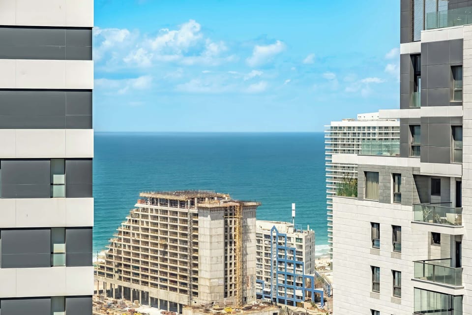 Stunning sea view framed between modern towers, offering peaceful coastal scenery just minutes from the apartment.