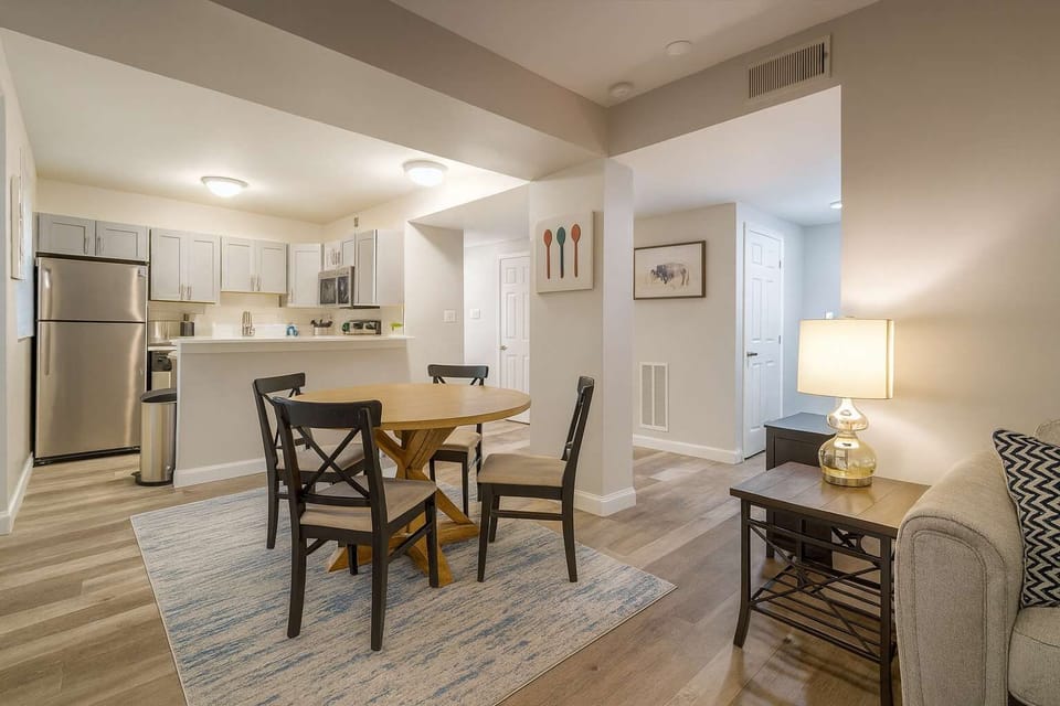 Bright living area with 55-inch smart TV · hardwood floors