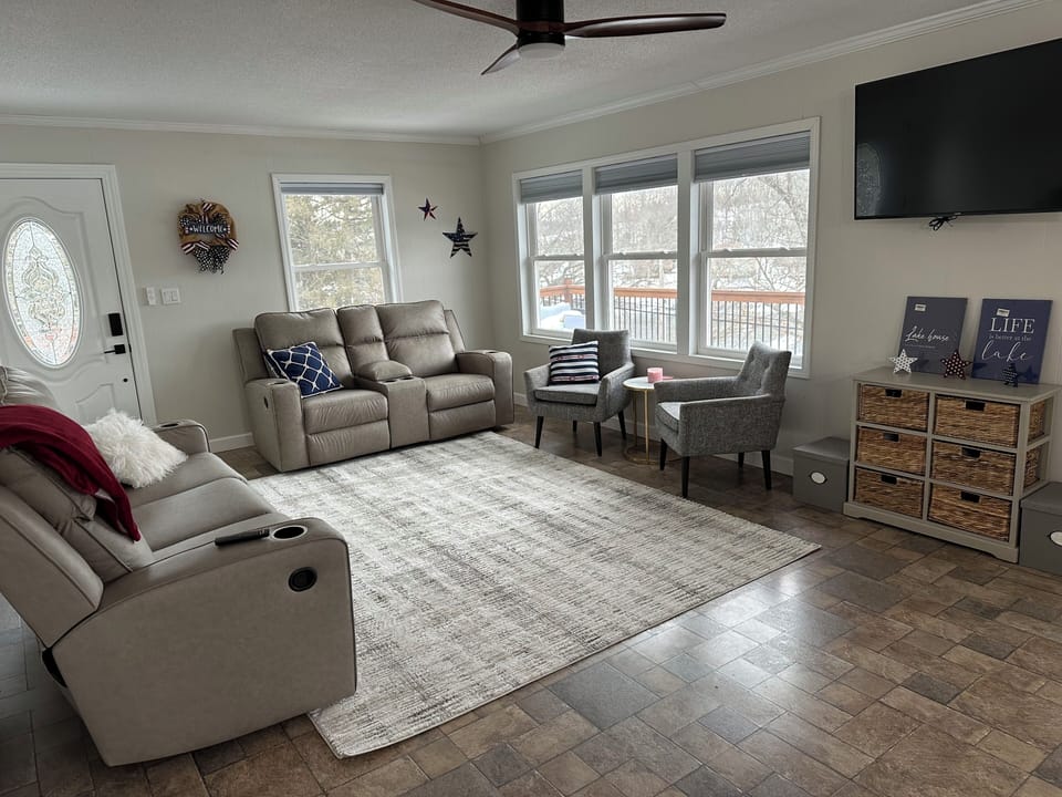 Main living room with lots of natural light and views of the lake.