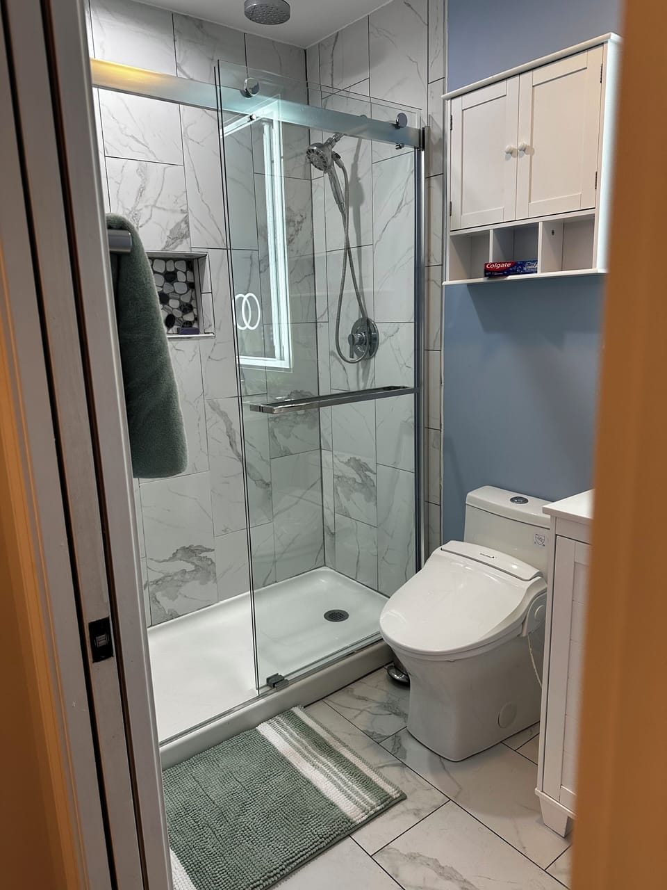 Mater bath with walk in shower and bidet toilet.