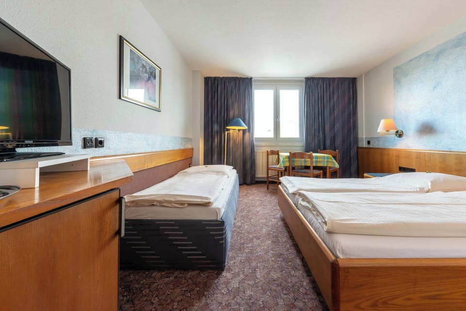 Family Triple Room, City View | Blackout drapes, soundproofing, iron/ironing board, WiFi