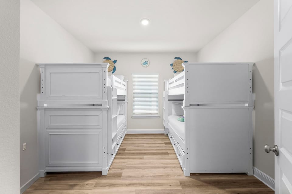 Your kids will love this bright bunk room with charming sea turtle decor and comfy sleeping spaces for the whole family.