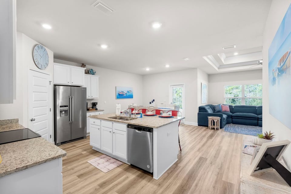 Your open-concept kitchen flows seamlessly into the cozy living area, featuring granite countertops, stainless steel appliances, and plenty of space to gather.