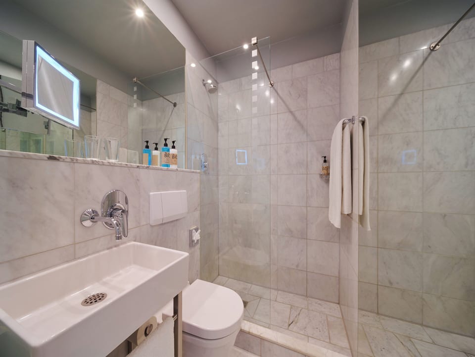 Eco-friendly toiletries, hair dryer, heated floors, towels