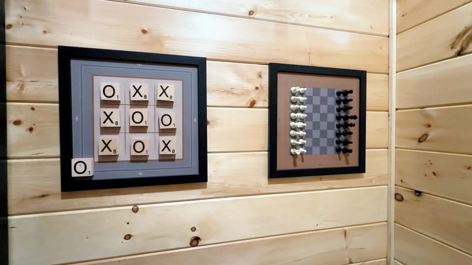 Framed chess & tic-tac-toe games light up the walls.