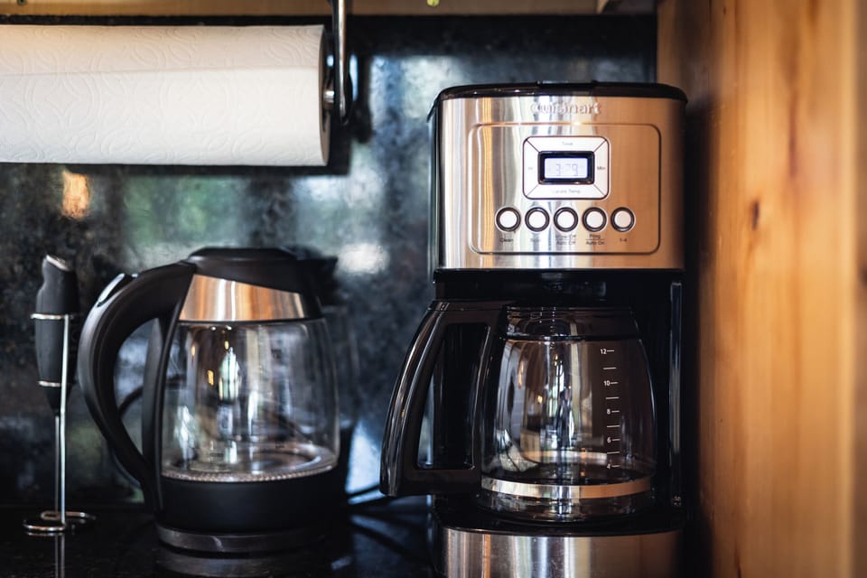 Coffee station with drip coffee maker and essentials for a great morning start.
