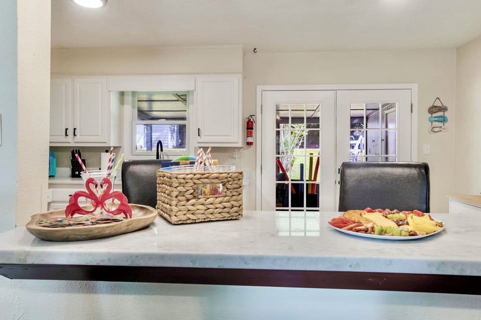 Open area kitchen bar with bar stools.  Photo props paper theme sunglasses for the kids (or big kids!)