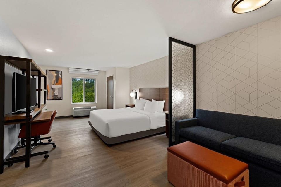 Wake up refreshed in a bright suite with cozy seating.