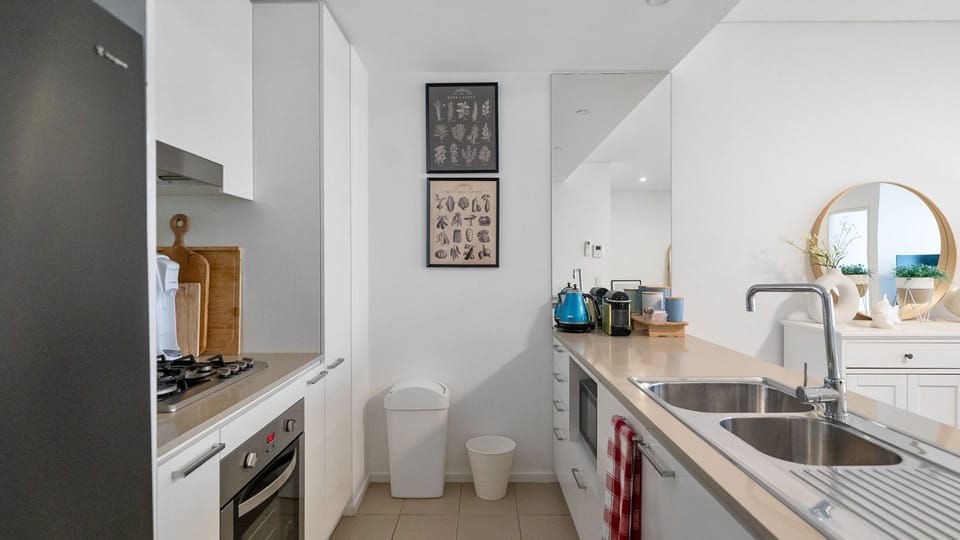 Fully equipped kitchen with oven, stovetop, and dishwasher.