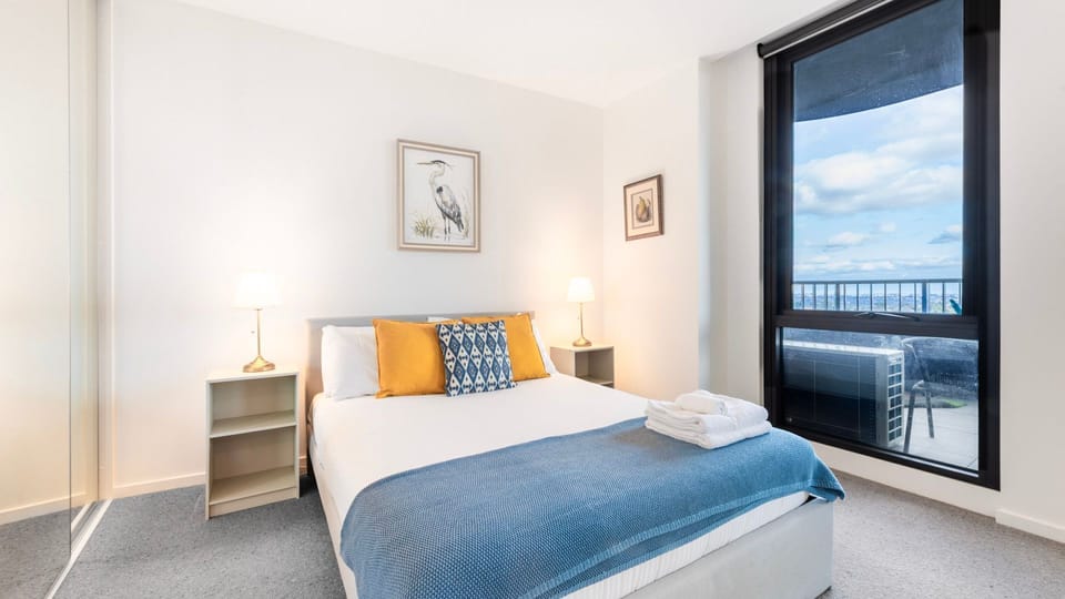 Bright and restful bedroom with plush comfort and balcony access