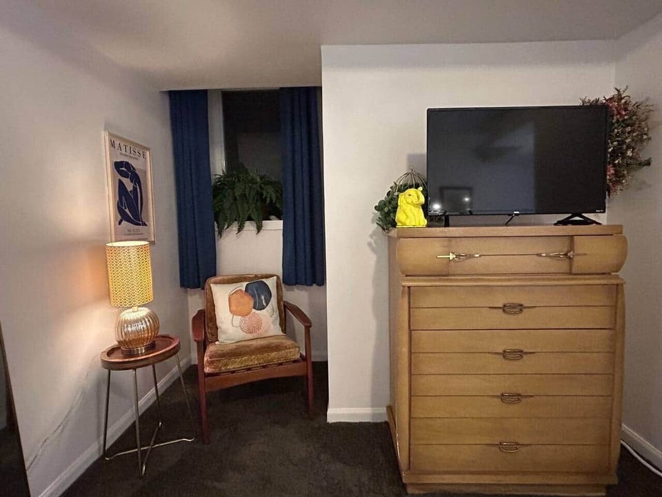 Enjoy relaxing in this reading nook in front of the large egress daylight window. Dresser and TV are provided for your use.