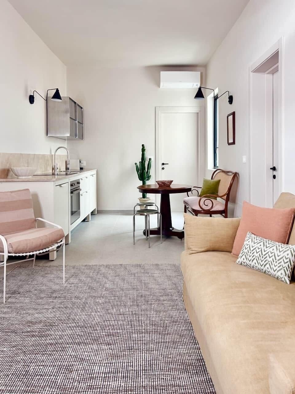 The open-plan living space blends cooking, dining, and relaxing with luxury textiles and modern ease