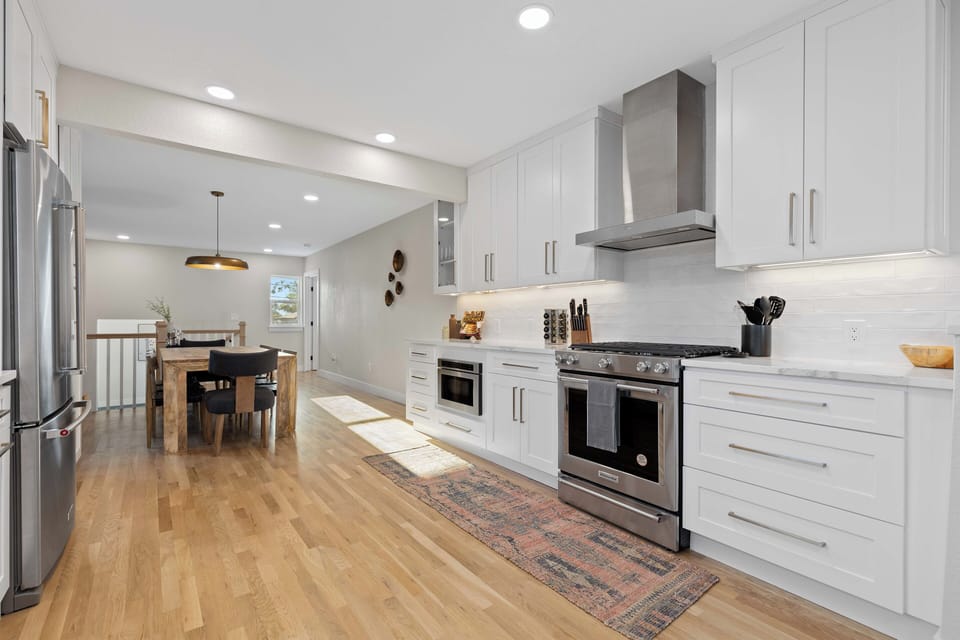 Fully equipped modern kitchen with open dining area.