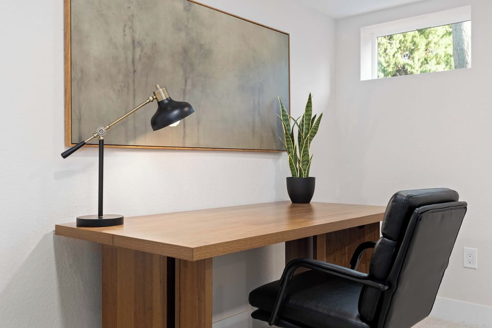 Private workspace with desk, comfortable chair, and natural light