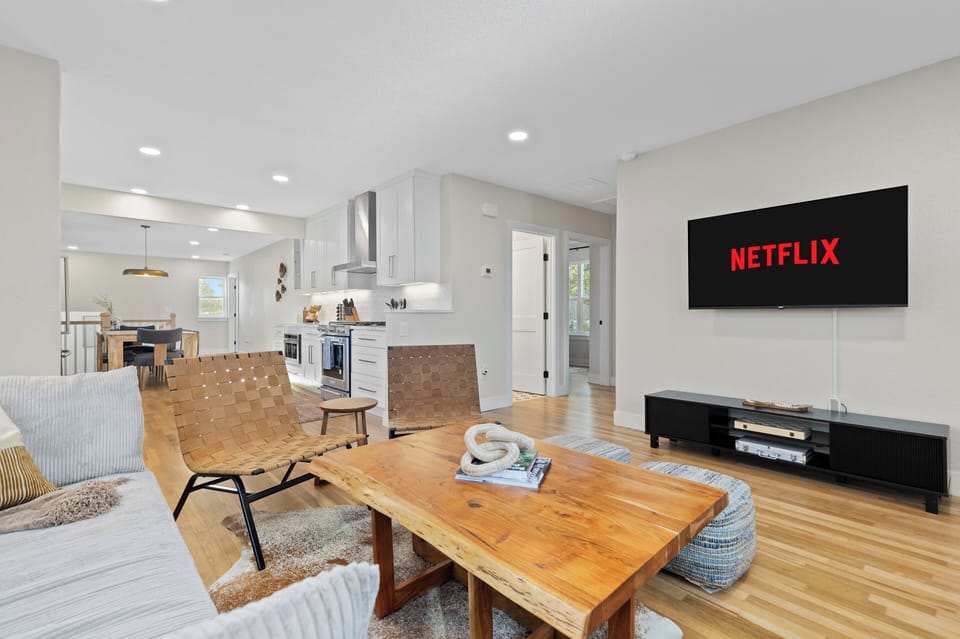 Spacious open-concept living area with smart TV and seating for groups