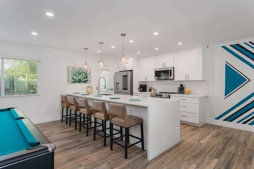 Fully equipped kitchen with stainless steal appliances and bar seating for 5 guests.