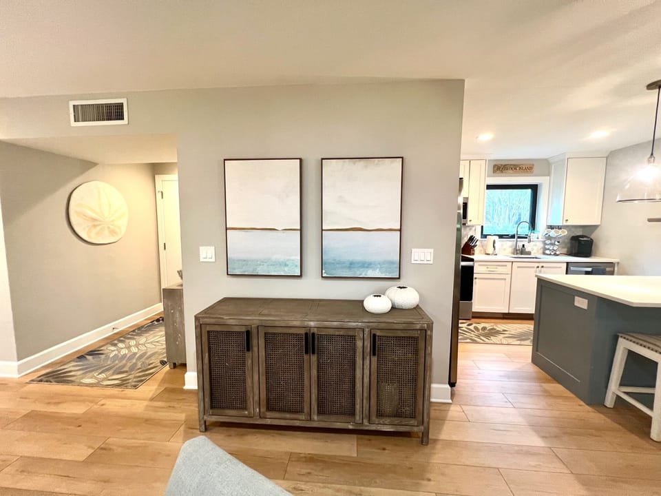 Step into coastal elegance with warm wood floors and breezy artwork that set the tone for your stay.