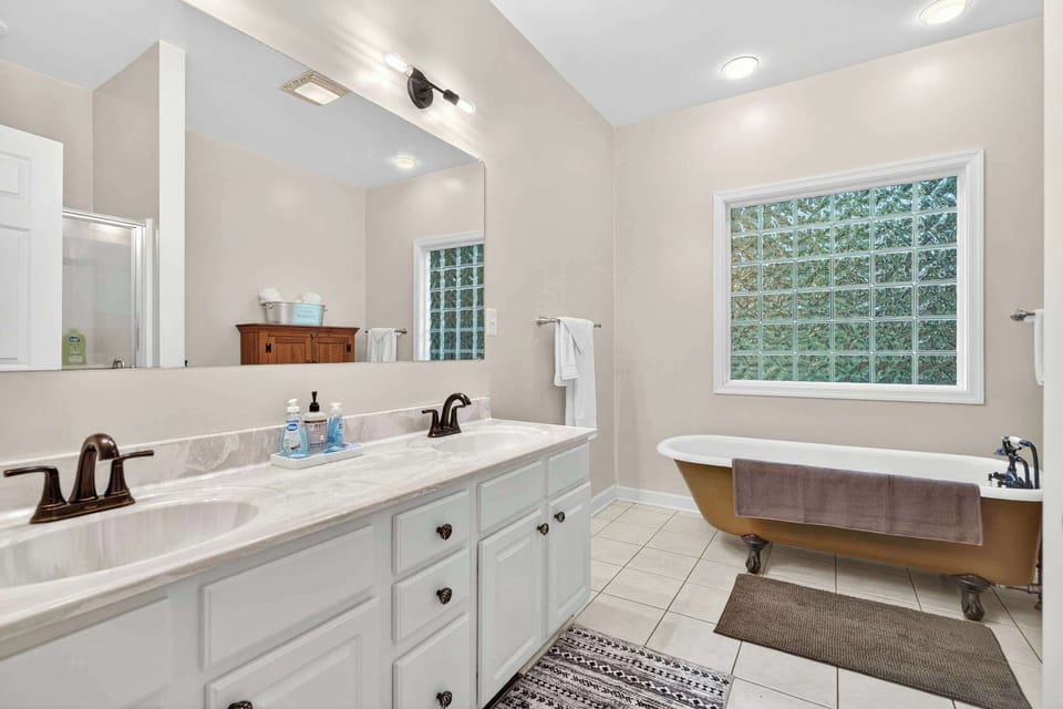 Relax in the spacious bathroom featuring a classic clawfoot tub and a separate shower