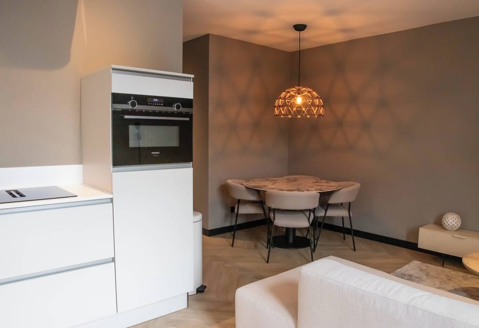 Elegant kitchen with character lighting
Cook in style with natural finishes and a welcoming dining setup.