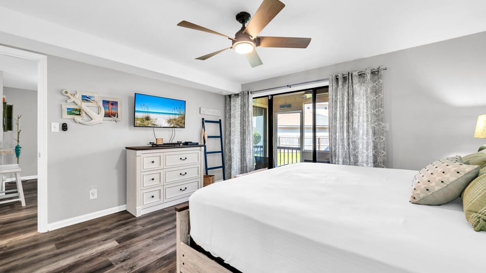 Bedroom With TV and  Access To Screened in Porch