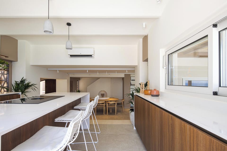 The fully equipped kitchen features all modern appliances, and adjacent to it is the dining area, comfortably seating up to ten guests.