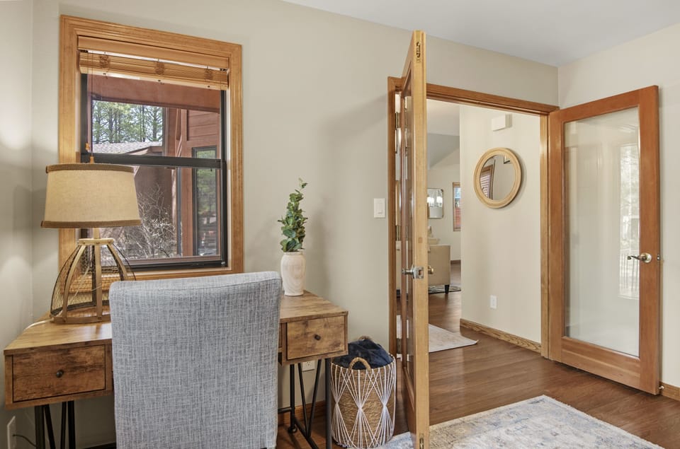 Desk in the office. View of the front porch. Glass doors to main living room.