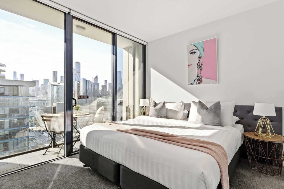 The second bedroom features a luxurious king-sized bed with plush pillows and a private balcony, your perfect retreat for comfort and fresh air.