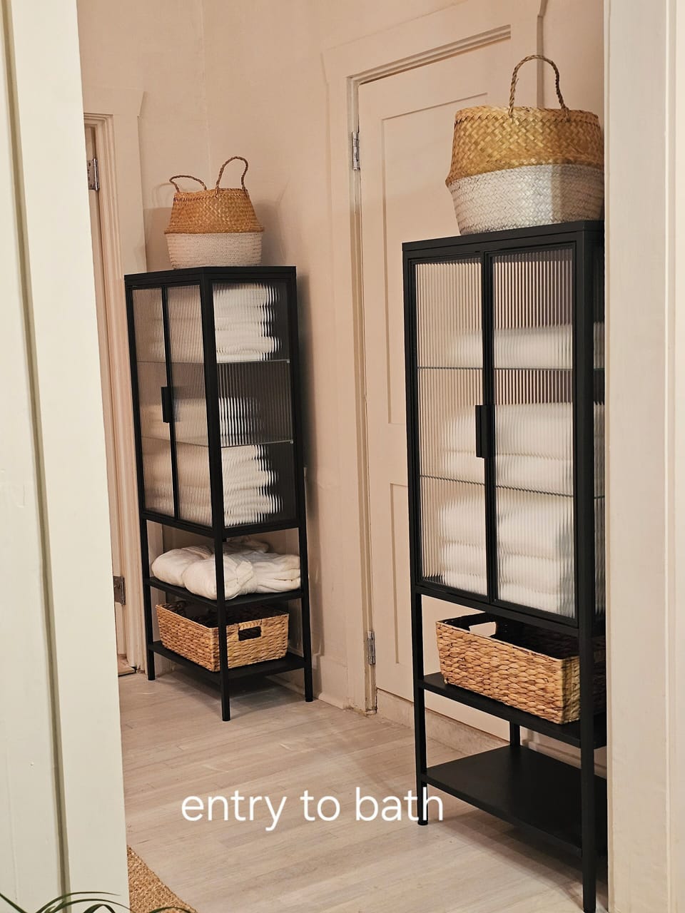 Storage cabinets for towels and robes, outside of bathroom 